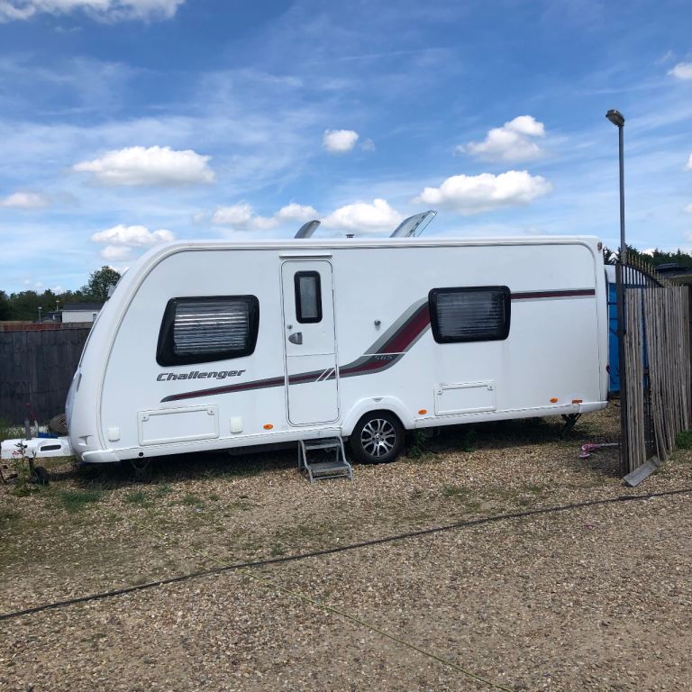 white Swift Challenger 565 caravan with maroon graphic accents and alloy wheels.
