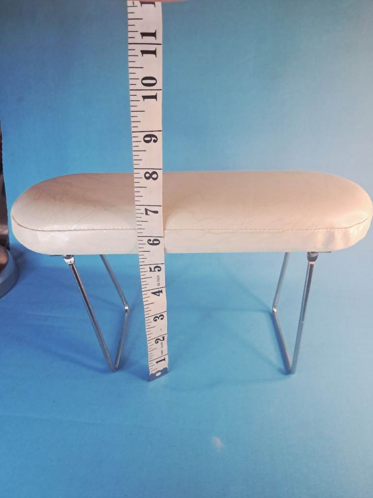 This is a white PU leather manicure nail arm rest with stainless steel support legs.Good condition