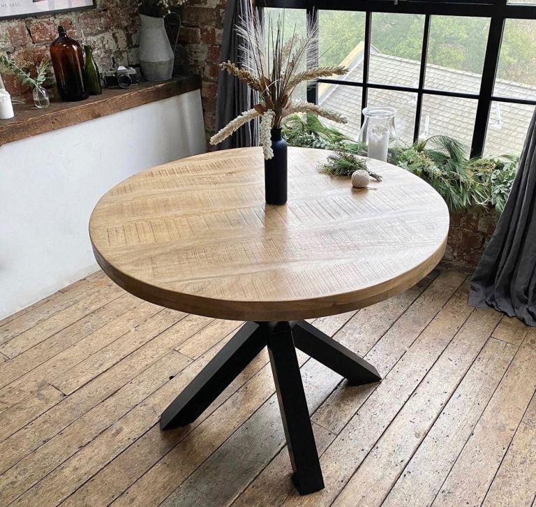 Rustic round wood dining table with industrial base