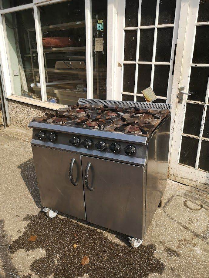 Commercial 6 burner cooker oven range runs on natural gas, delivery available.