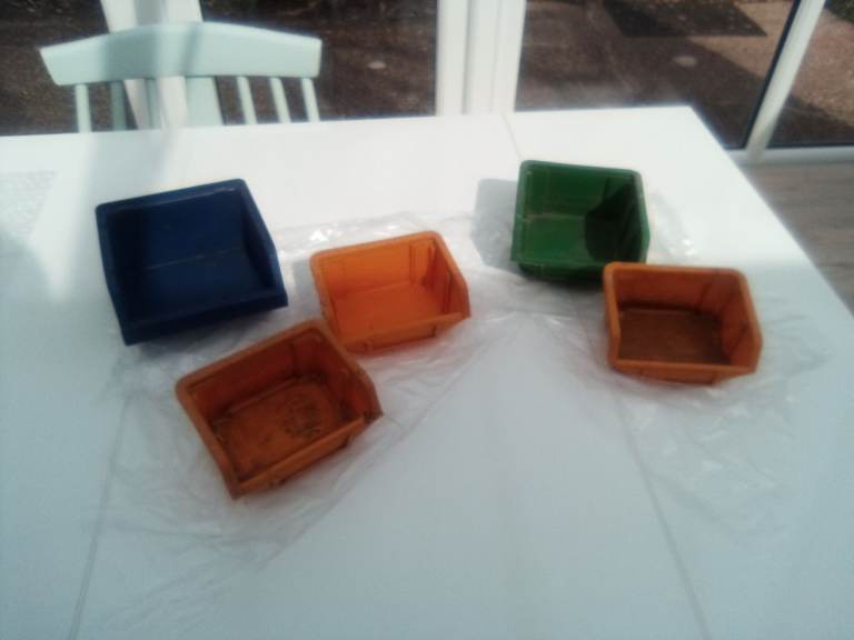 Garage, shed or workshop small plastic stacking storage boxes.