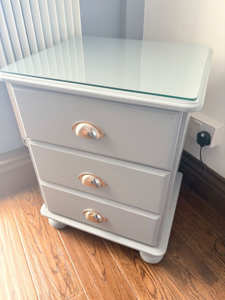 One single bedside cabinet with glass top