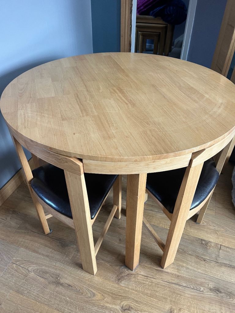 Compact Round Wooden Dining Table with Tuck-Under Chairs