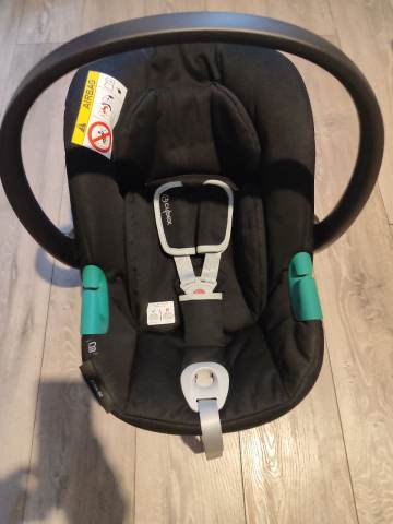 evenflo gold pivot Xpand Modular Travel System with LiteMax Infant Car Seat (Sabino Gray) fish cooler bag cradling baby at a Philly eagles helmet COLOR:GREEN TOP/ YELLOW BELLY W/BLACK EYE
