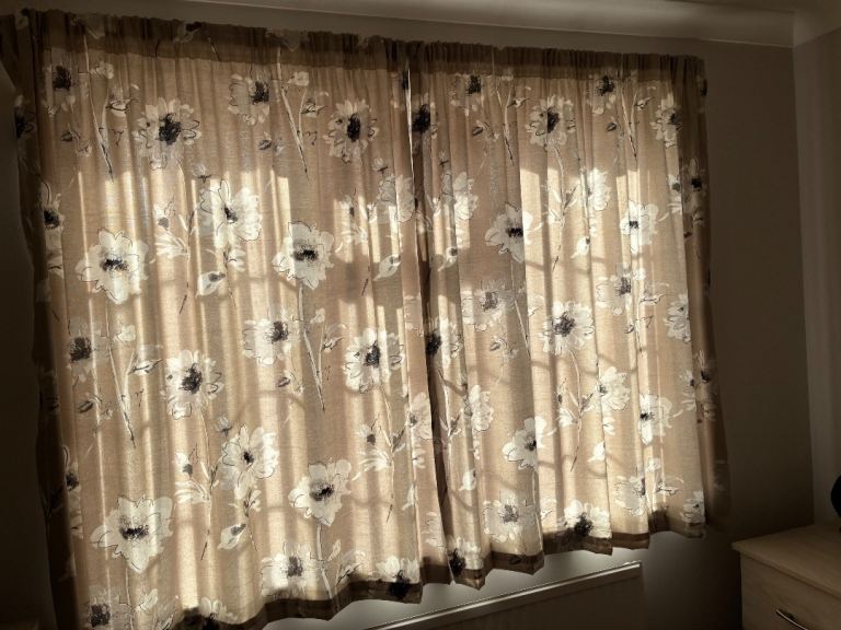 A pair of curtains size each curtain is 66 ins wide and 60 ins long 