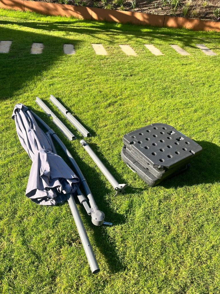 Grey offset parasol grey parasol with weighted base.