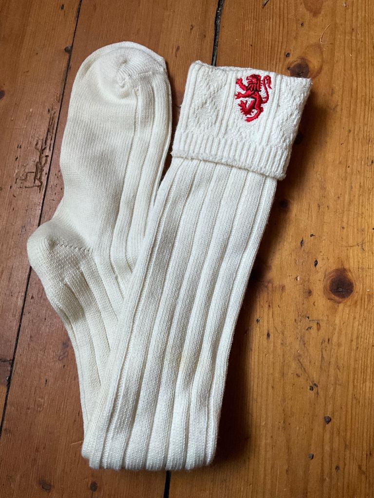 Mens cream kilt socks with red embroidered lion rampant on outside 