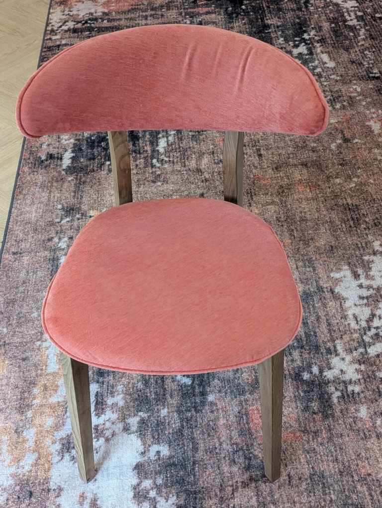 8 Lasio dining chairs in Titan 305 Vintage Red aquaclean®️ Fabric, legs are Ash.
