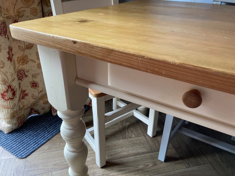  solid table with drawers and four chairs , cream legs /base -edging  