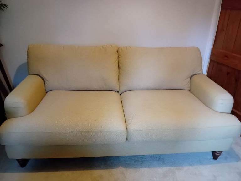 Pale yellow two seater sofa (DFS)