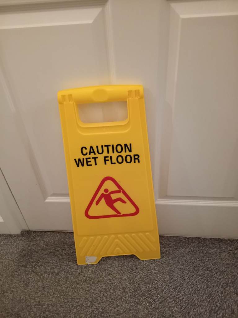 Plastic caution wet floor sign