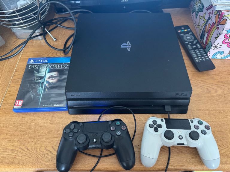 PlayStation 4 Pro Console with Two Controllers and Game