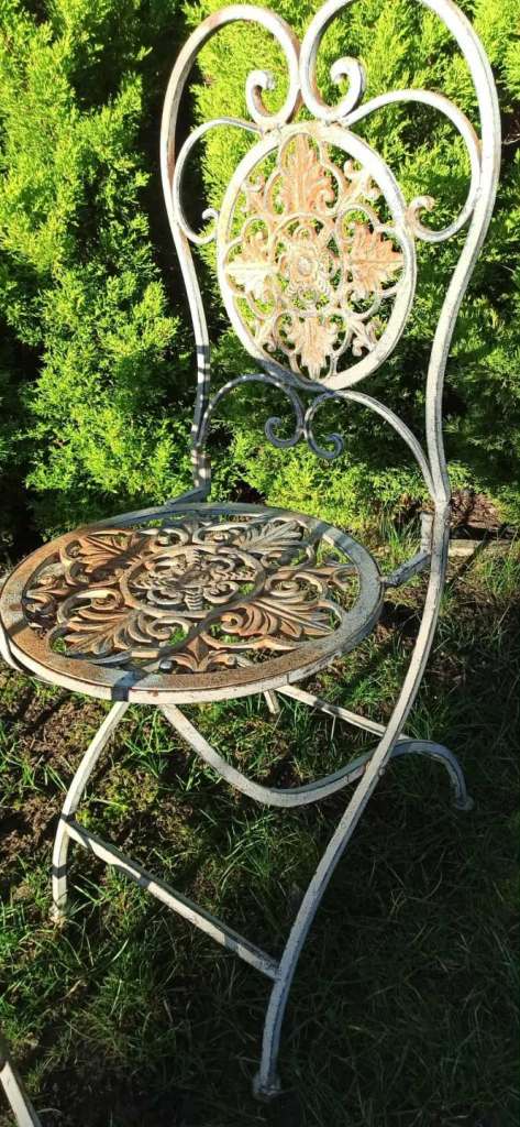 Wrought iron garden furniture set, vintage bistro set with a table and two chairs. 