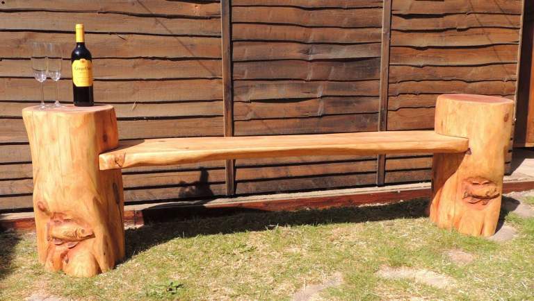Beautiful chainsaw carved bench made from exotic redwood.