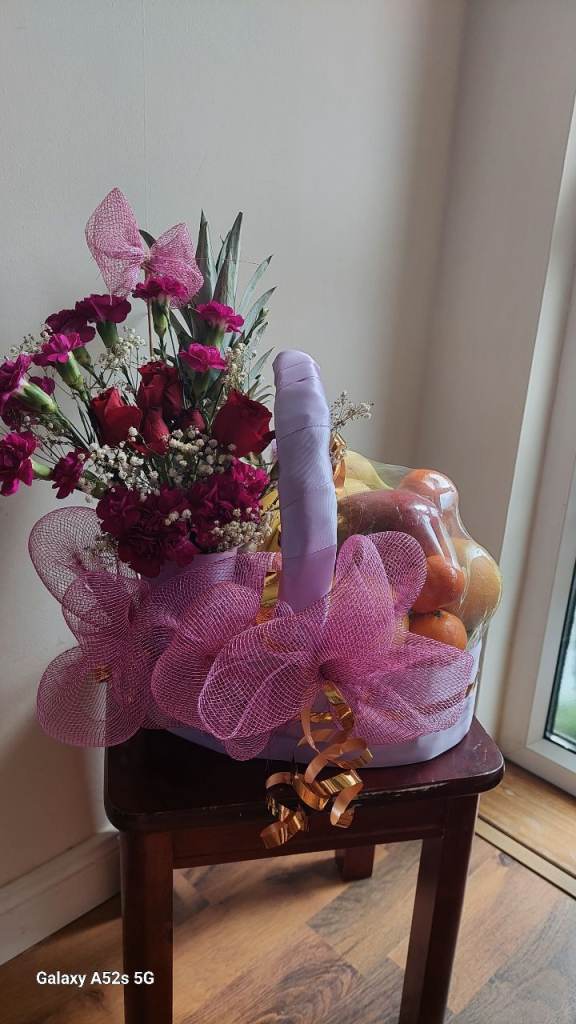 gift basket with flowers and fruits suitable as a gift for any occasion