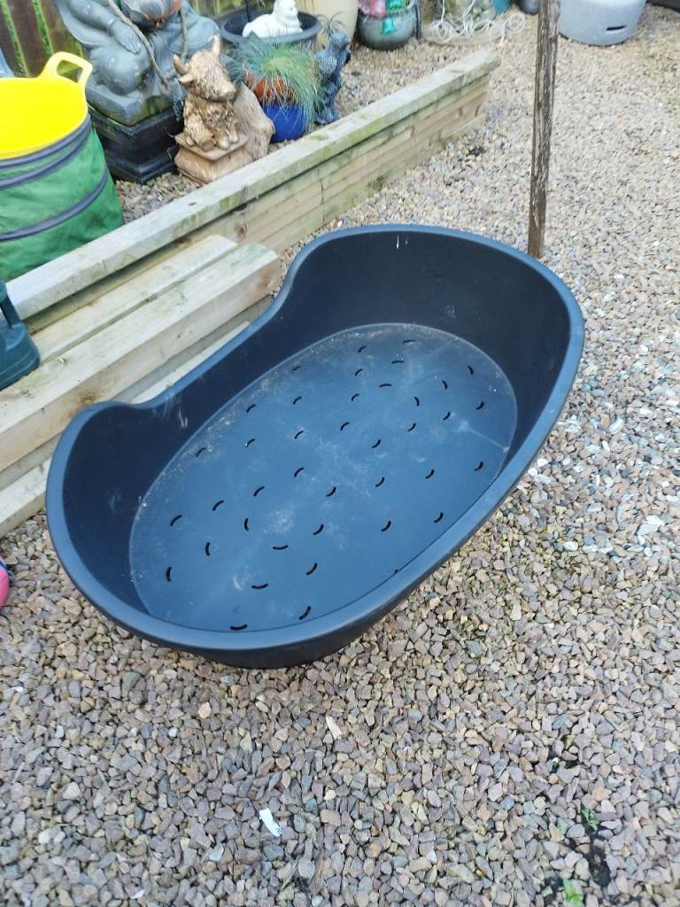 Large black plastic pet bed