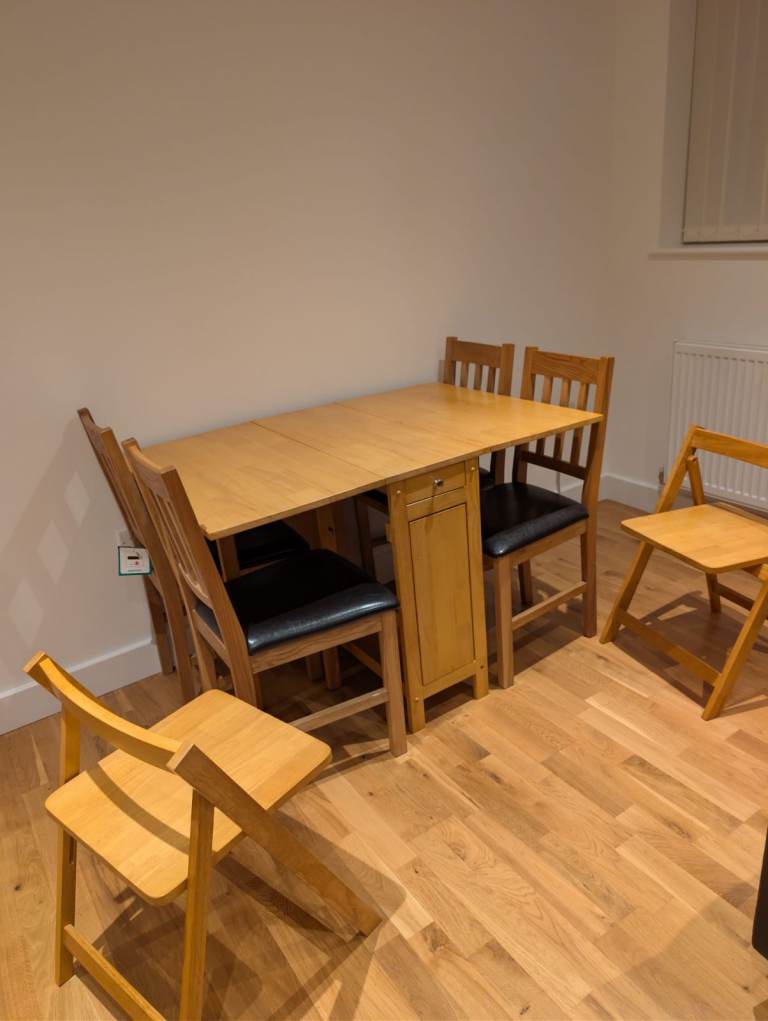 Wooden Drop-Leaf Dining Table with 4 Folding Chairs + 4 Dining Faux Leather – Good Condition