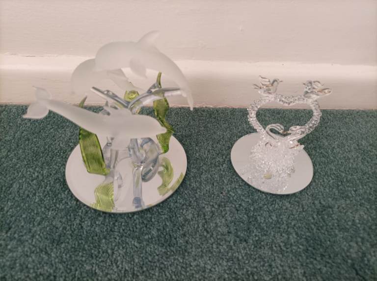 Two glass animal ornaments on mirrored bases 