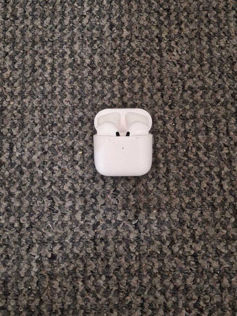 A white pair of wireless earbuds