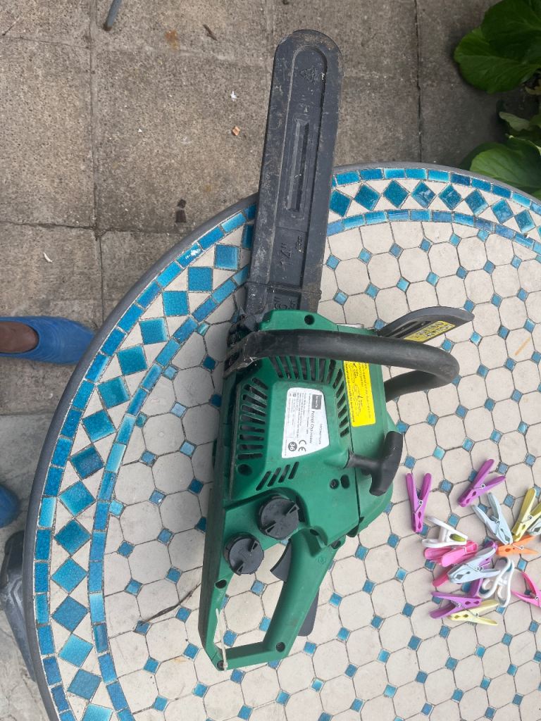 Green Chainsaw - Good Condition, Ready for Garden Work