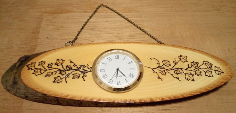 Hand made hanging wooden clock with Pyrography Ivy Leaf Design log end