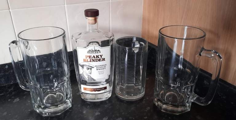 Peaky Blinders bottle and 3 large beer glasses