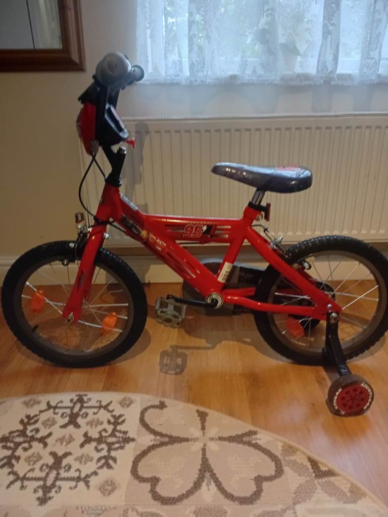 Red children's bicycle featuring a 95 design on the seat and handlebars. With Pump Included