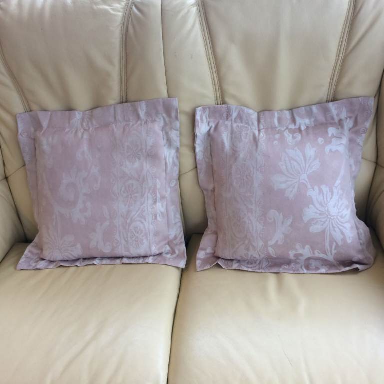 A pair of sofa cushions, beige print