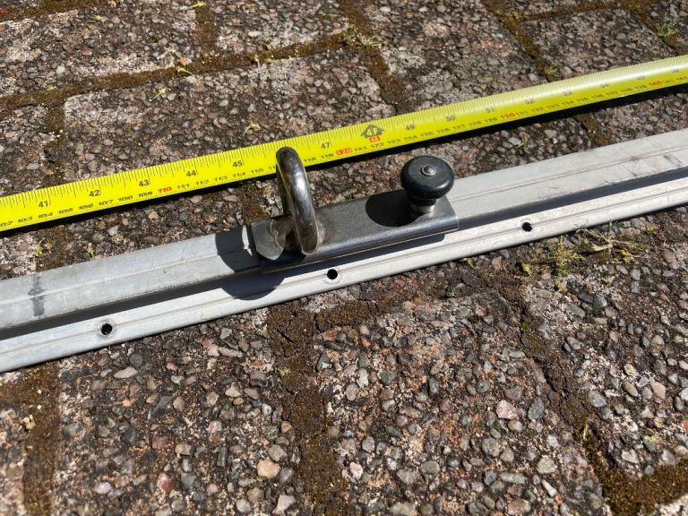 Curved spinnaker pole track and pin stop car