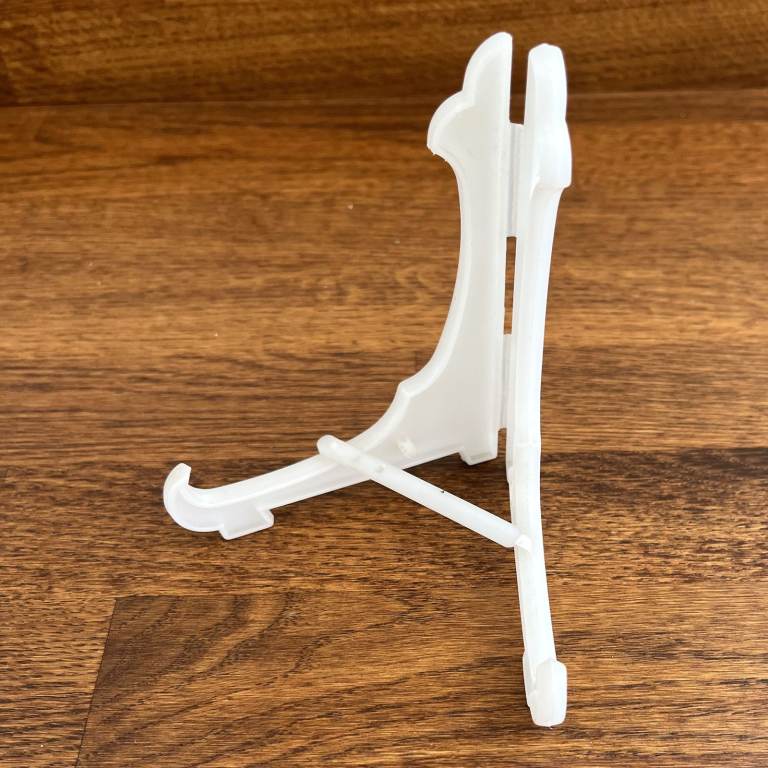 Display  stand, white plastic. Small plates, bowls, tiles, cards, books, photo frames, etc. CAN POST