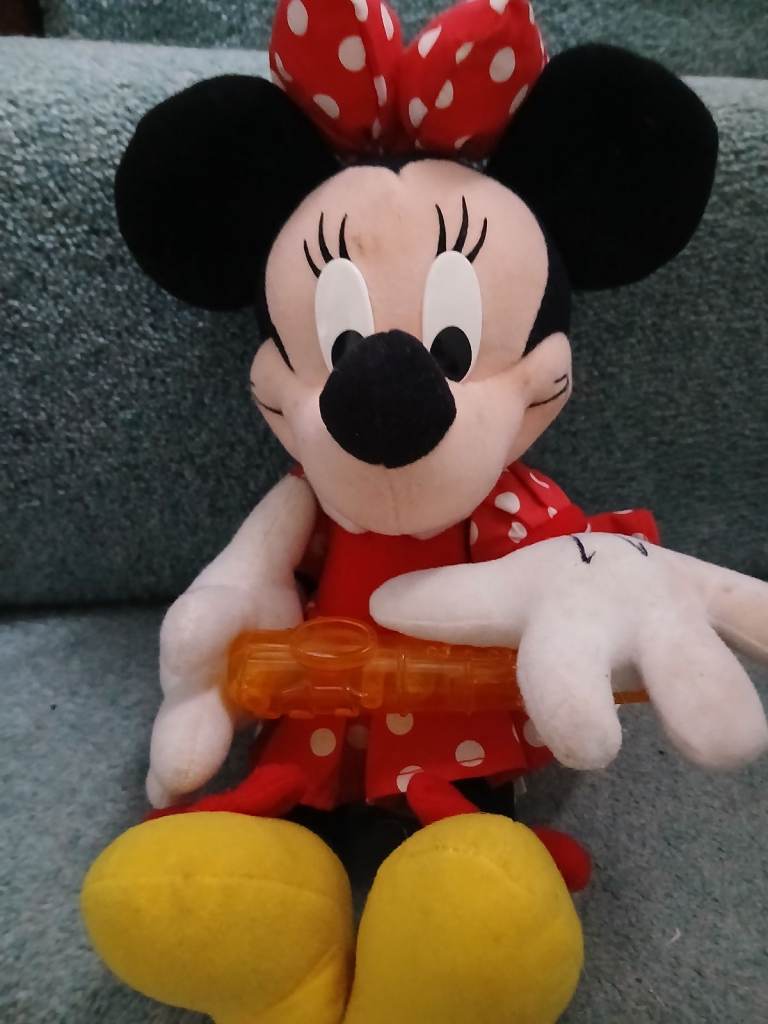A Minnie  Mouse with instrument. 