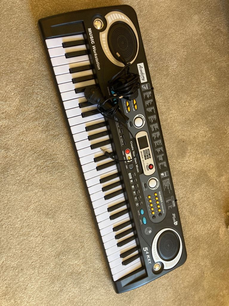Black Electronic Keyboard with Microphone – Good Condition