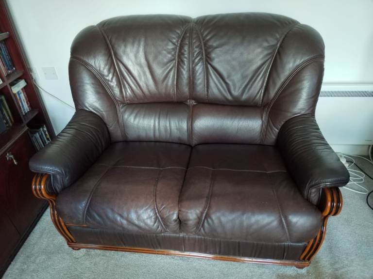 Italian leather sofa, two seater, dark brown, carved wood inlay on arms & base