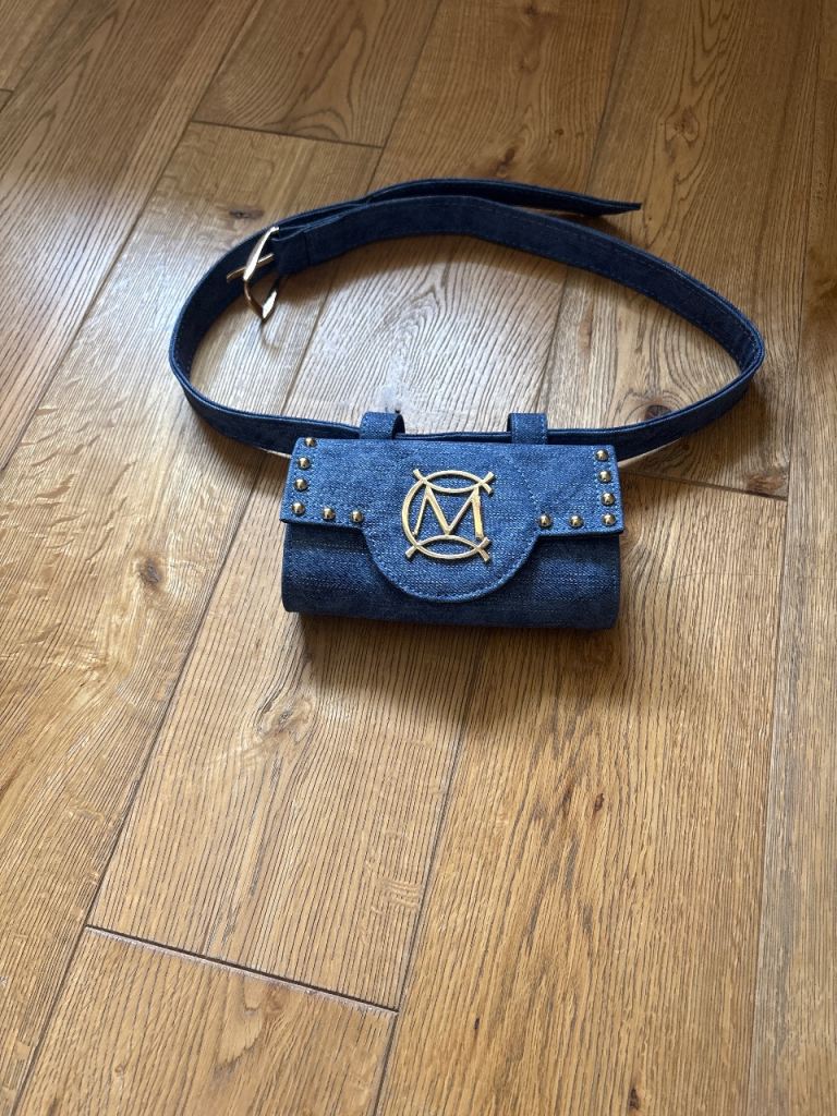 This is a blue denim Massimo Contti Luxury Brand belt bag with gold studs and a matching denim belt