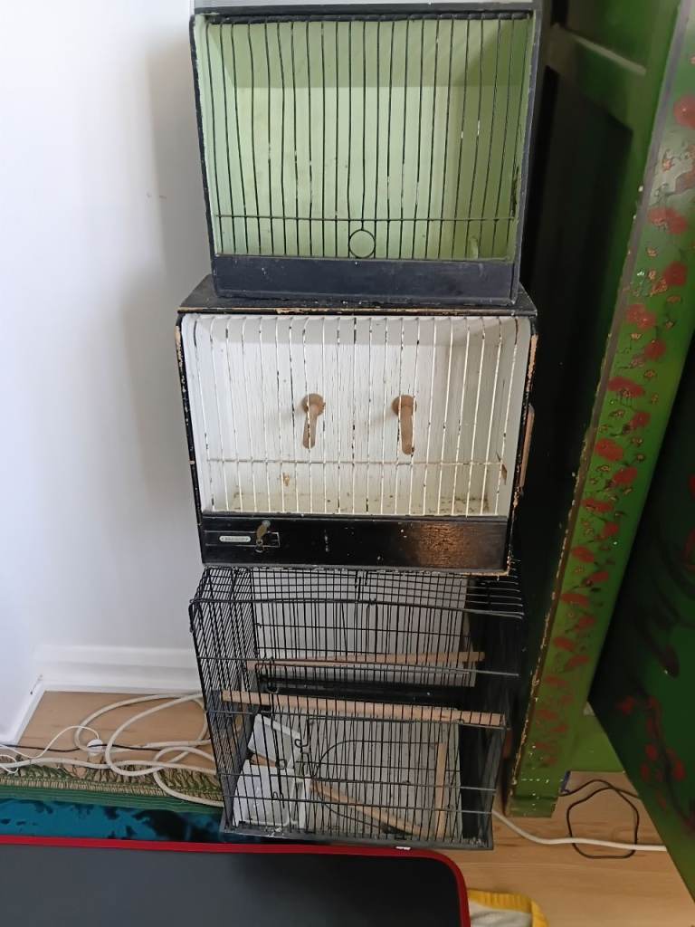 A very large black cage and two transportrt cages