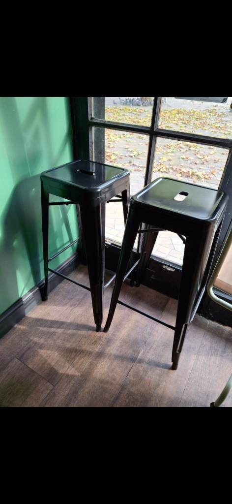 2 black metal bar stools