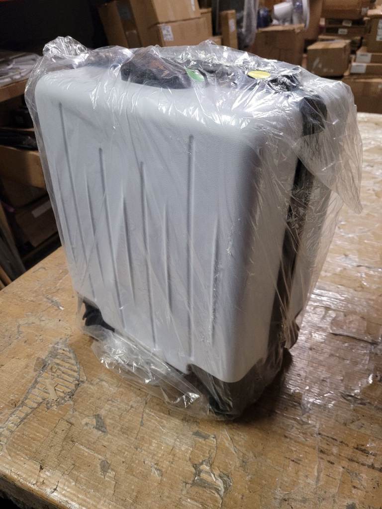 A new white x black hard shell 15 inch suitcase with folding cup holder .
