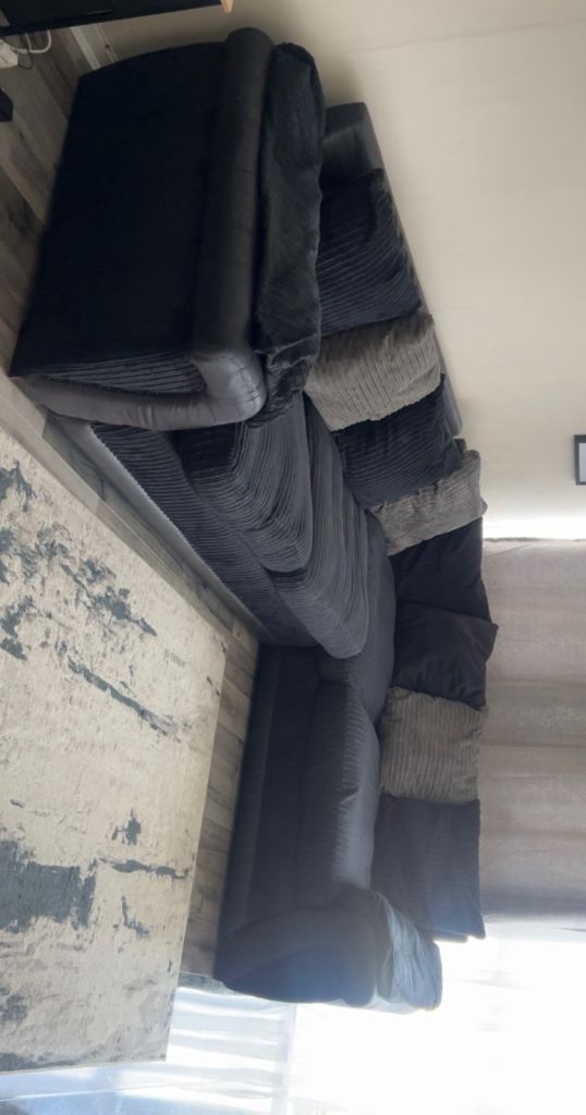 Large right hand corner sofa. Black with grey sofa 