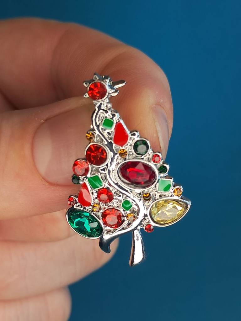 Christmas Tree  brooch with multi-color rhinestones and a rhodium-plated finish..
