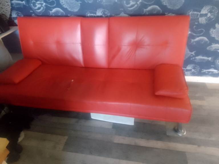 Red two seater sofa bed 
