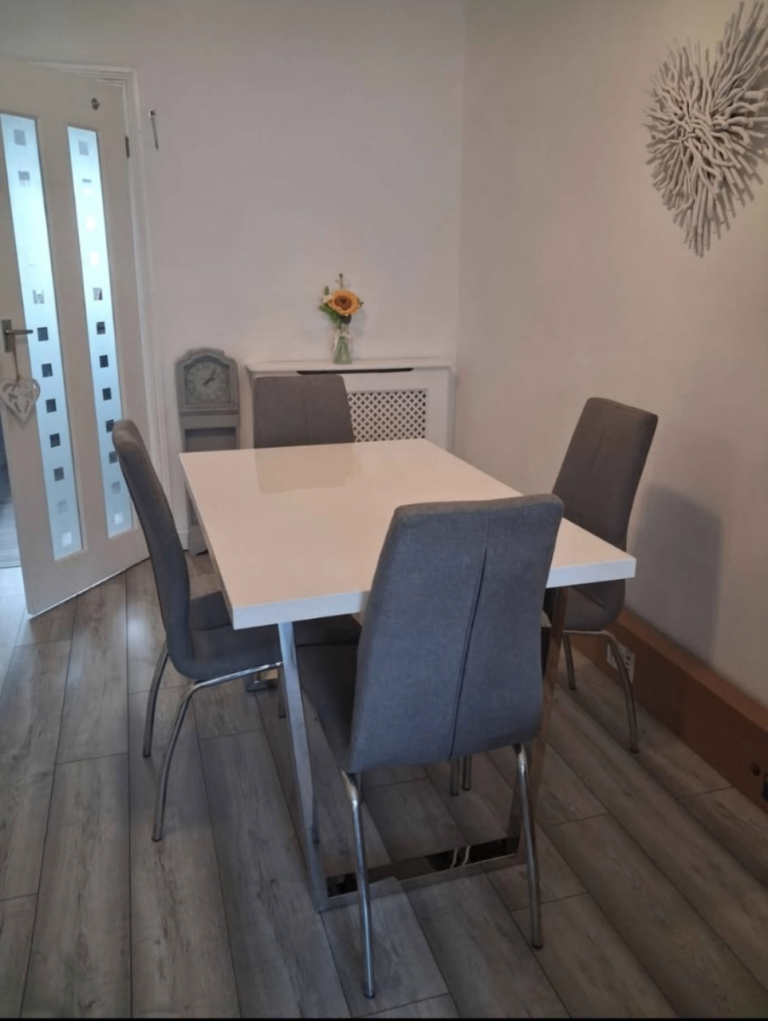 White dining table and four grey chairs 