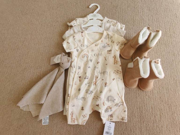 3 body suits, 2 comforters and 2 pairs of baby boots