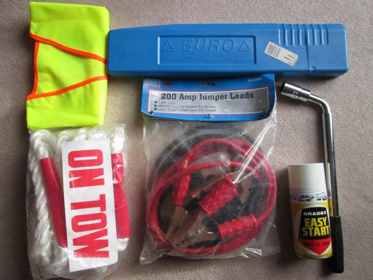 Car boot emergency kit tow rope warning triangle, jump leads, wheel wrench, hi-vis vest, start spray