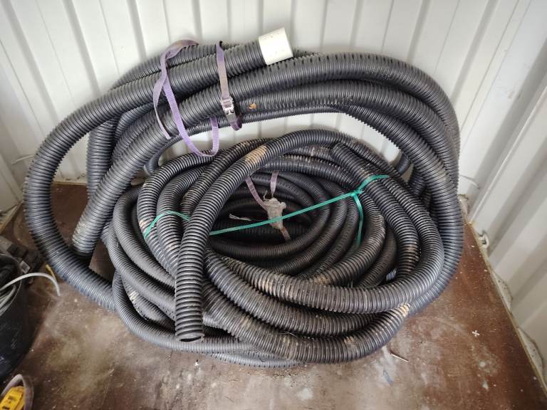 Large Coil of Black Corrugated Drainage Pipe / Hose