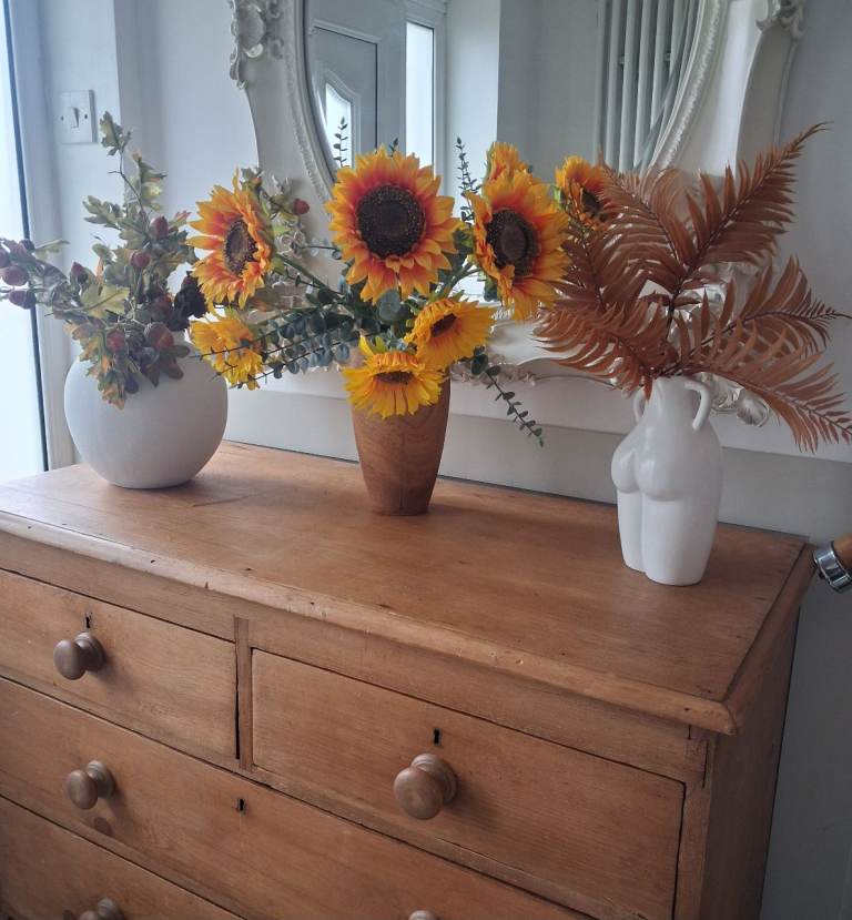 Three autumn flower arrangements with vases 