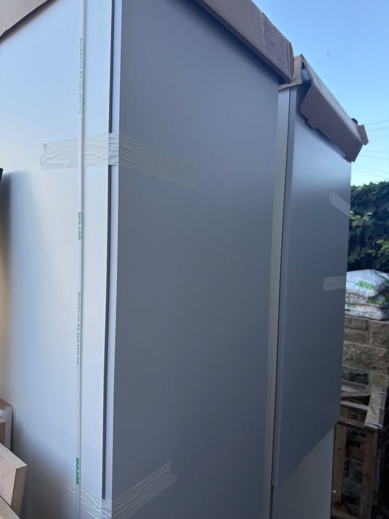 Tall larder unit with door and shelves