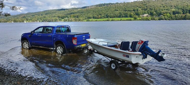 Small Fishing Boat with Trailer and Outboard Motor