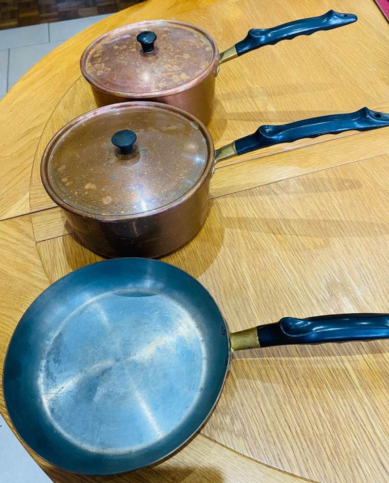 copper saucepans and a frying pan