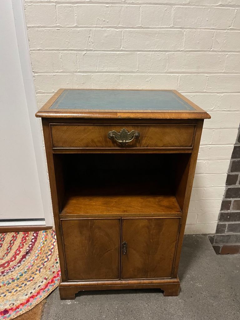 Vintage wooden cabinet with lock and leather surface