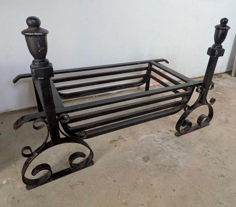 Beautifully crafted wrought iron grate with two fire dogs.